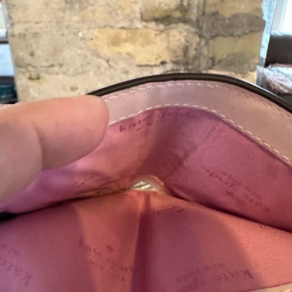 Kate Spade wallet is a light pink wallet adorned with small heart-shaped studs - Picture 13 of 16